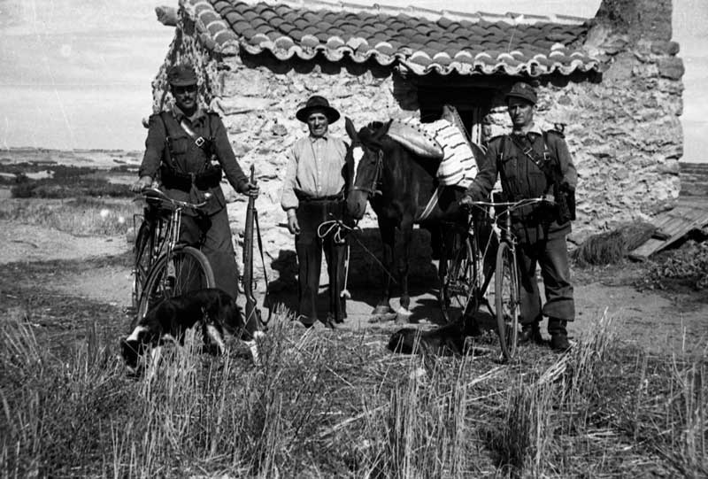 Pareja con paisano junto a la caseta de vigilancia de frontera.